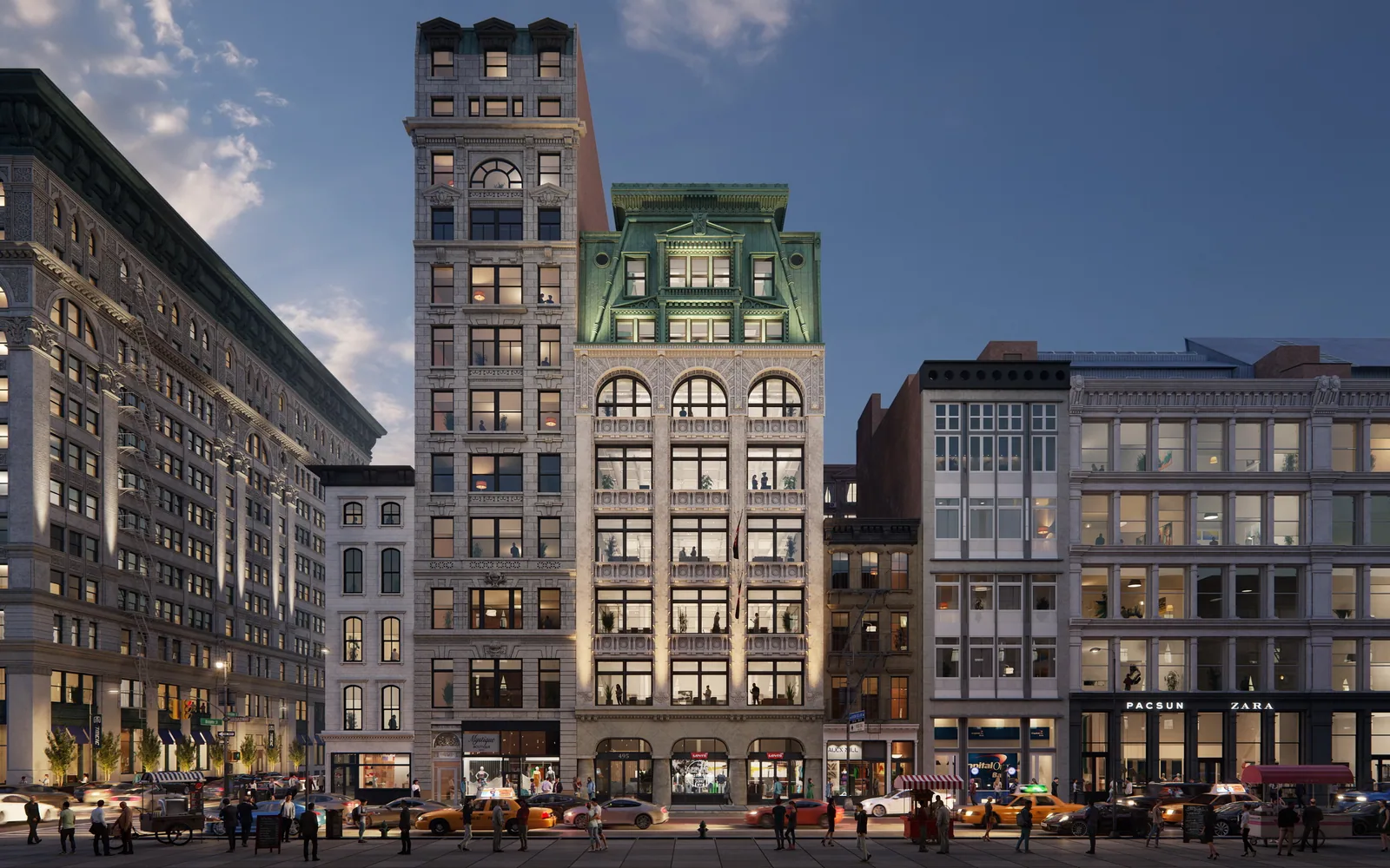 Historic building at 495 Broadway in SoHo, New York, with arched windows and green crown at dusk