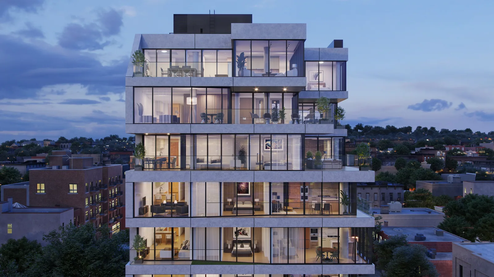 Upper floors of 651 Fourth Avenue in Brooklyn at dusk with lit apartments behind glass