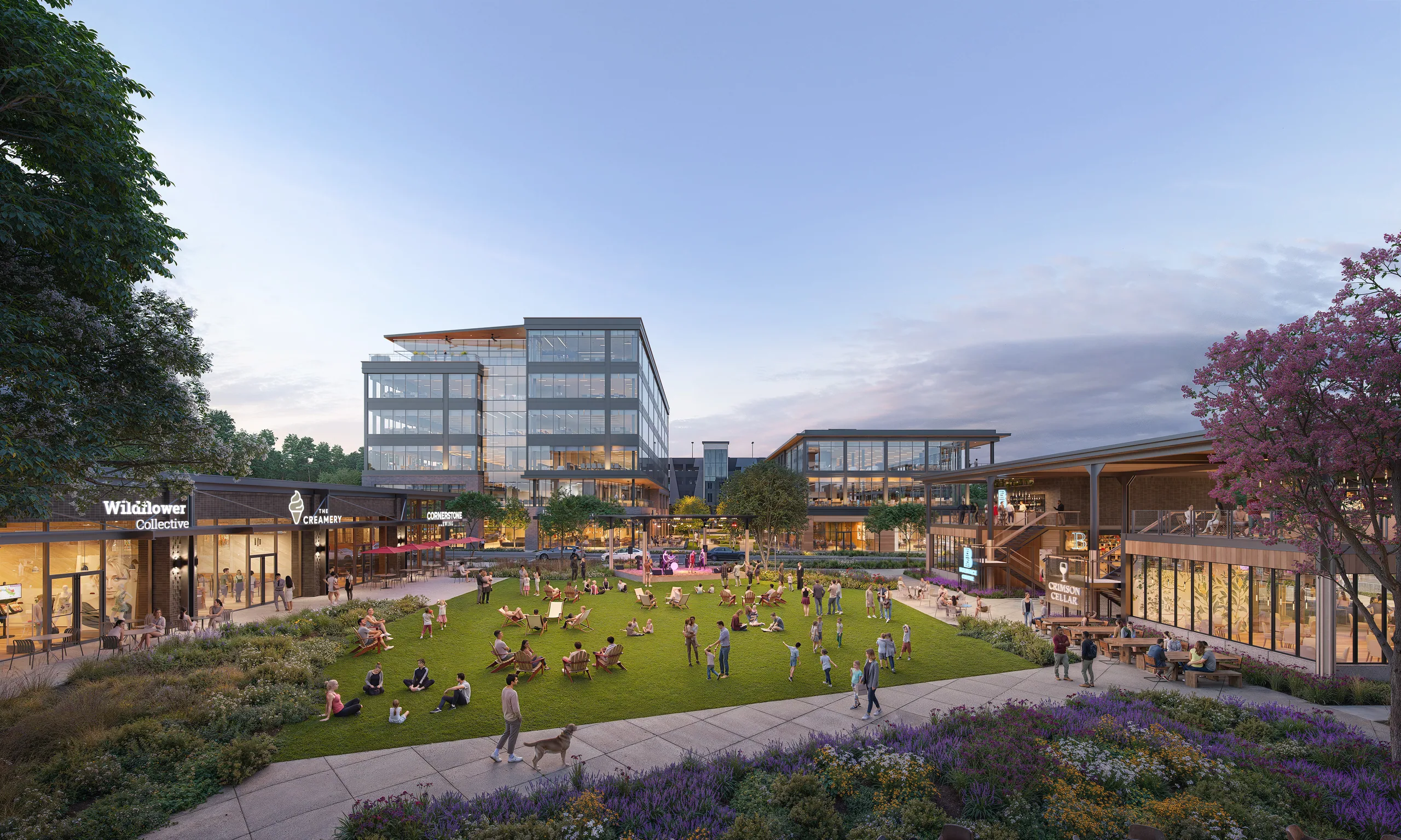 Central lawn at Alston Yards in Cary at sunset with people, shops and glass office buildings