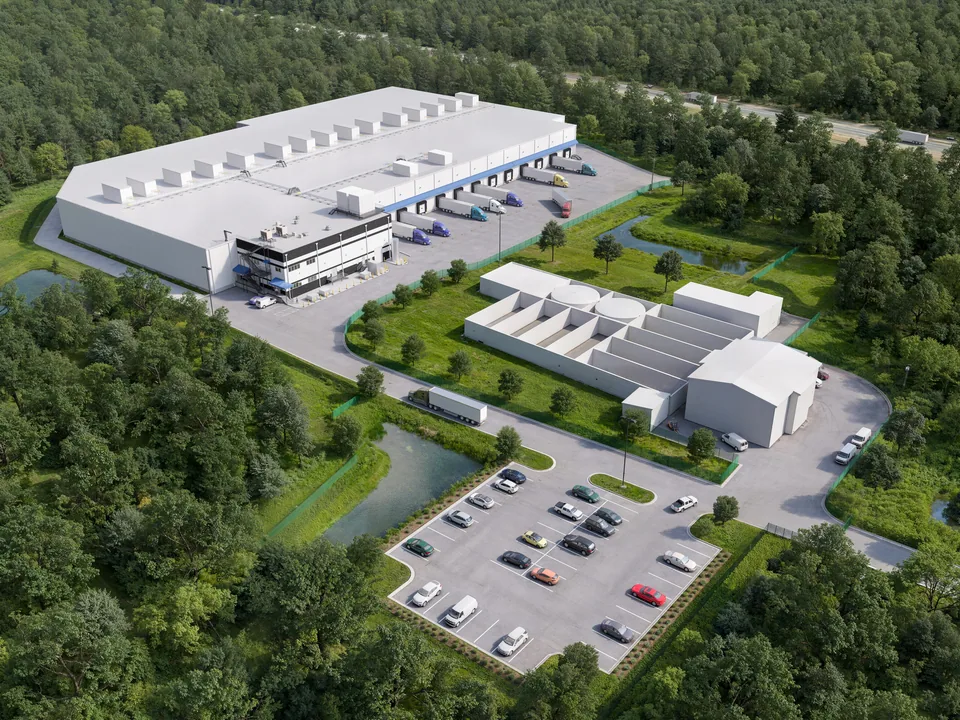 Aerial of the Americold cold storage warehouse in Middleboro, Massachusetts, among woods