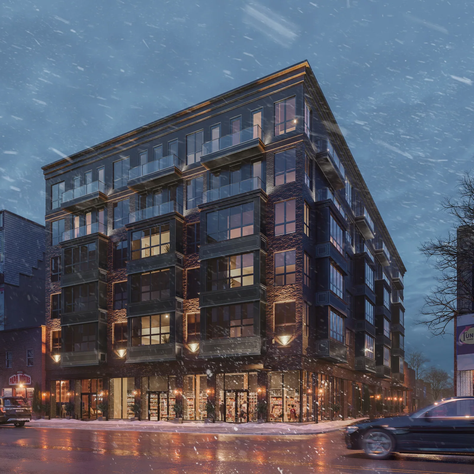 Dark brick residential building with glass balconies at Copper Boulevard, Philadelphia, on a snowy evening