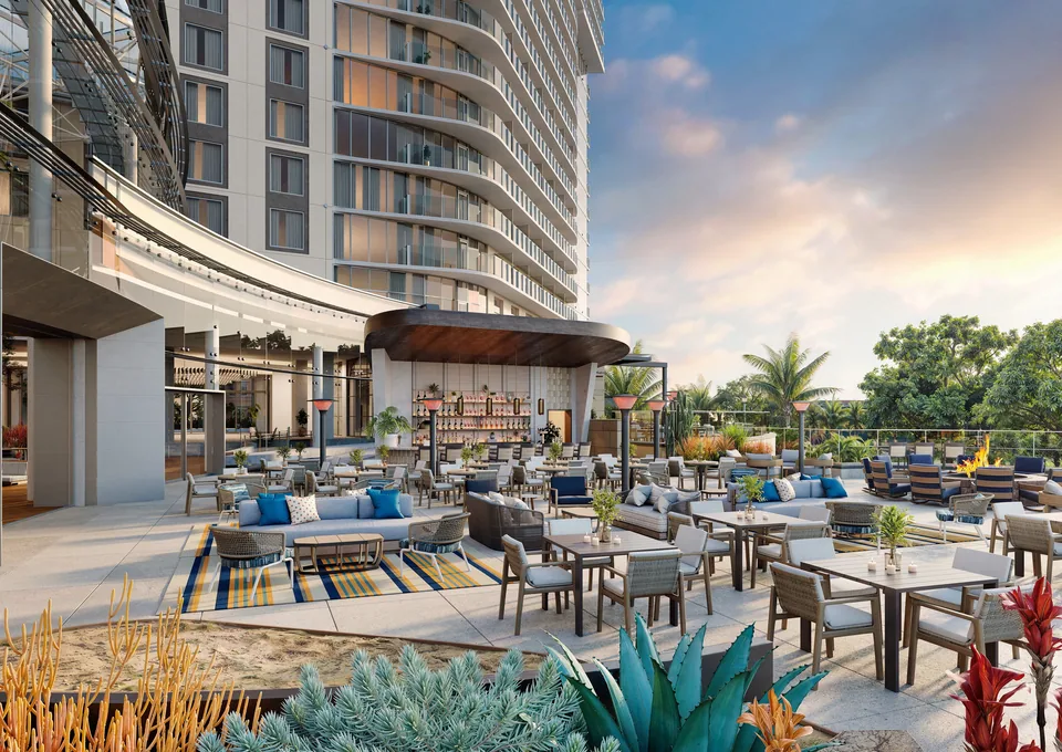 Open-air terrace restaurant with lounge seating beside the hotel tower at Gaylord Pacific Resort & Convention Center at sunset
