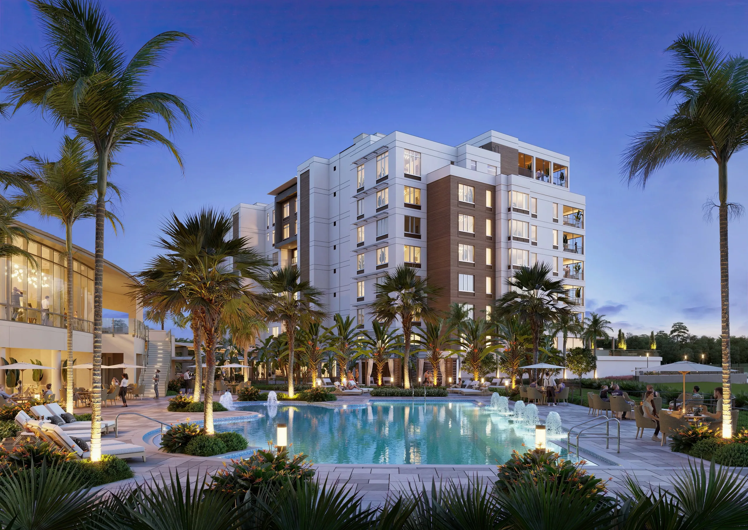 Senior living residences and palm-lined resort pool at Moorings Park Grande Lake, Naples, at dusk