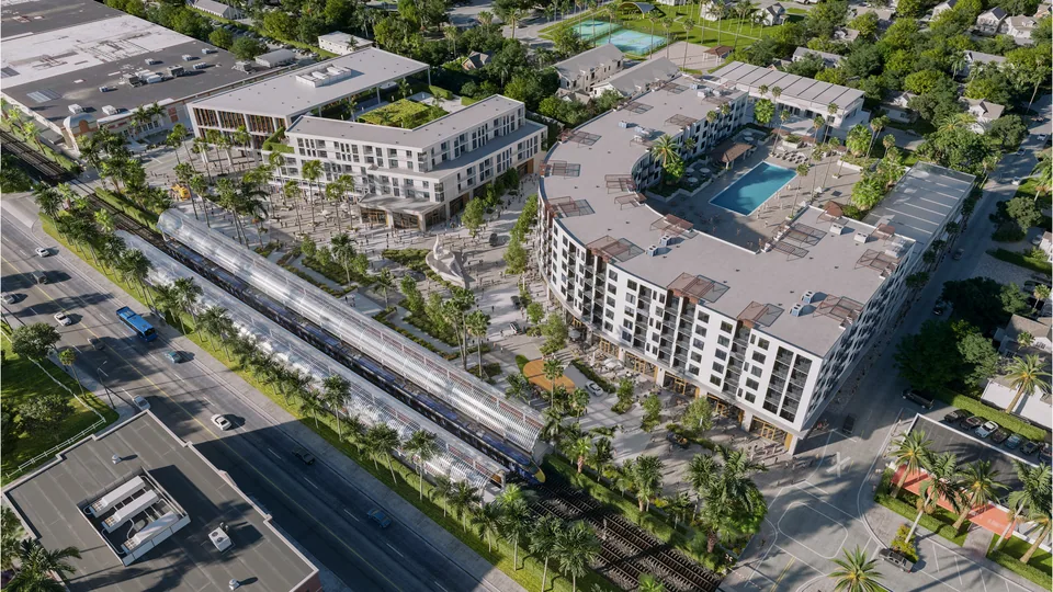 Aerial of the Sky Building mixed-use project with pool courtyard beside the rail line in Sky Building, Florida