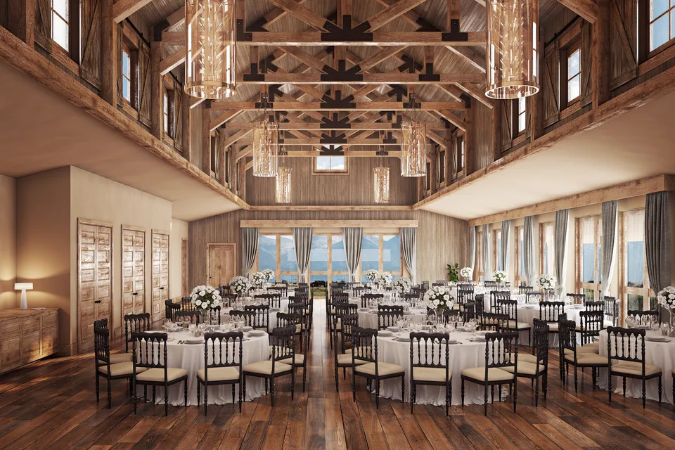 Timber-trussed event hall set for dinner with chandeliers at Sage Lodge, Montana