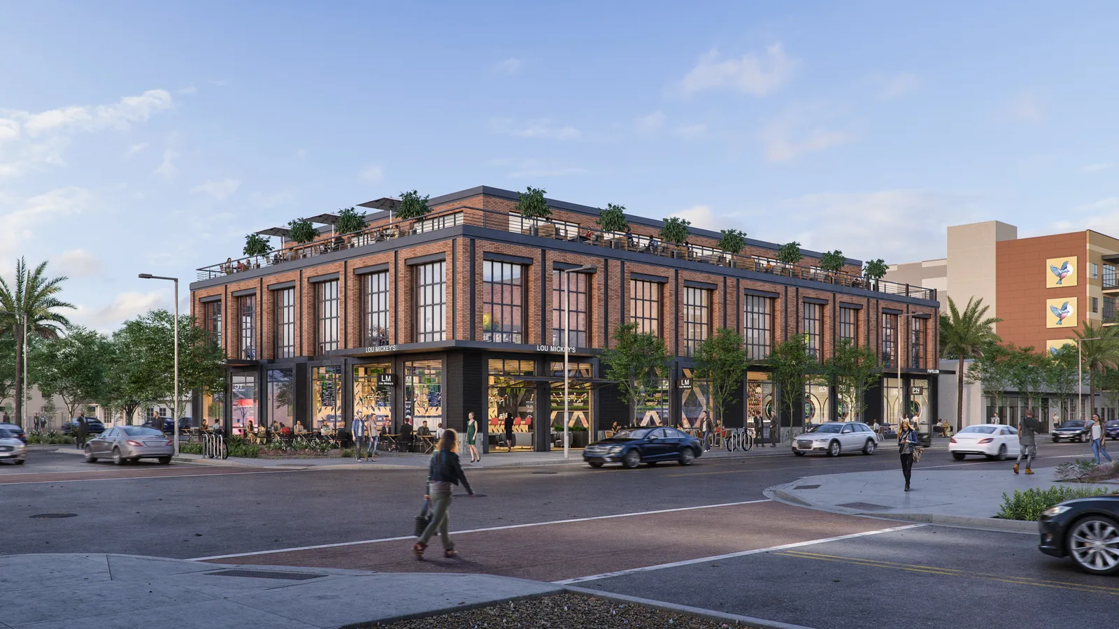 Brick office building at 1005 N. 2nd St in Phoenix with corner storefronts, roof terrace and palm-lined street