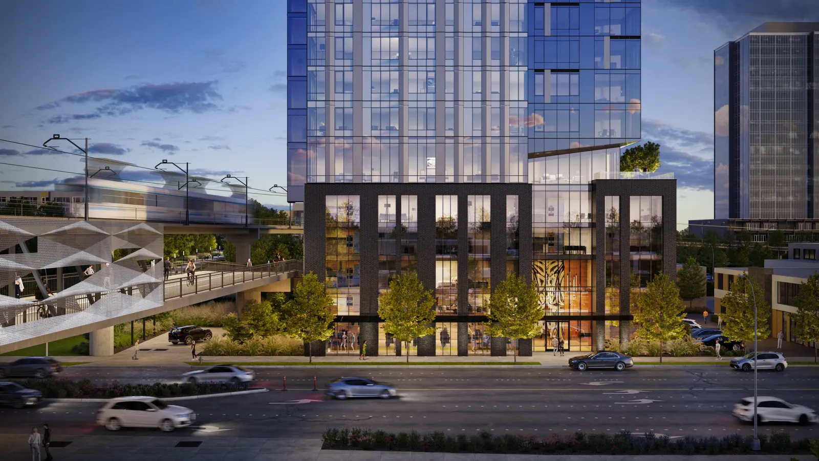 Tower base at 11635 NE 8th St in Bellevue at dusk beside the elevated light rail station
