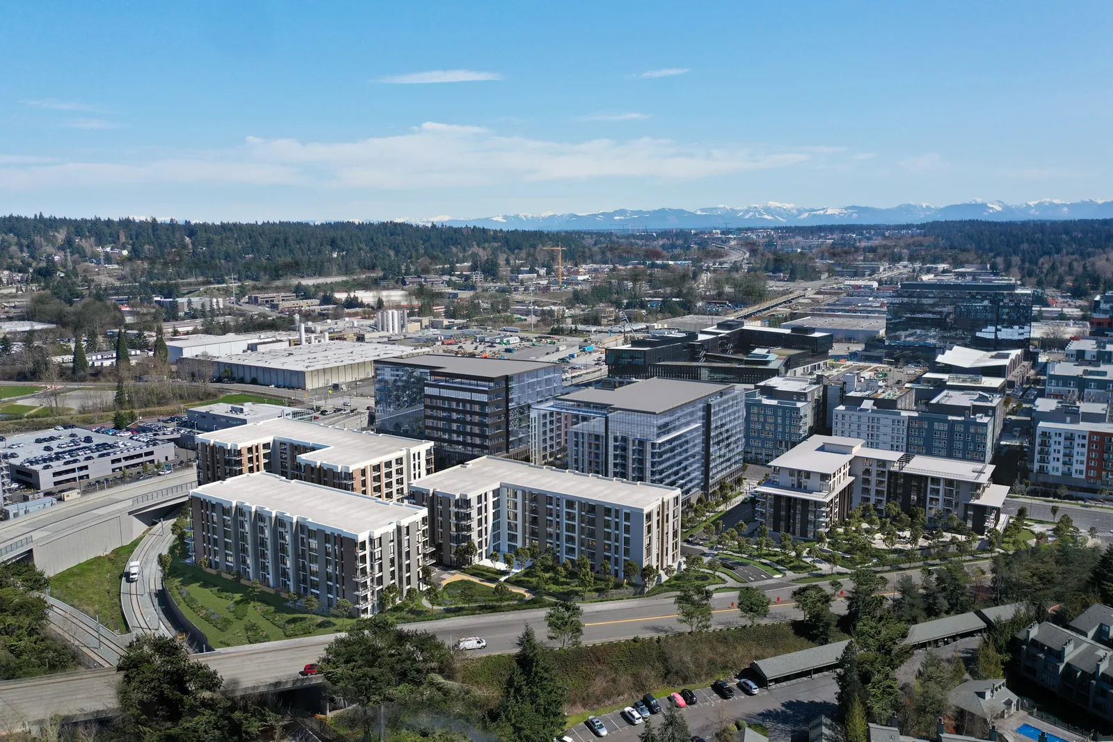 Aerial of the 12th Street campus in Bellevue with office and residential blocks and the Cascades beyond