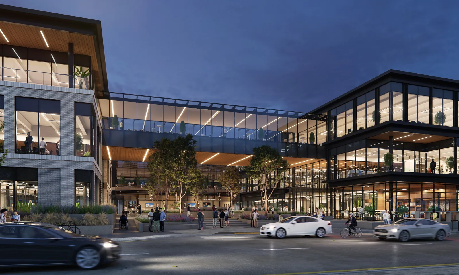 Life science buildings at 1021 Howard Avenue in San Carlos joined by a glass bridge, seen from the street at dusk