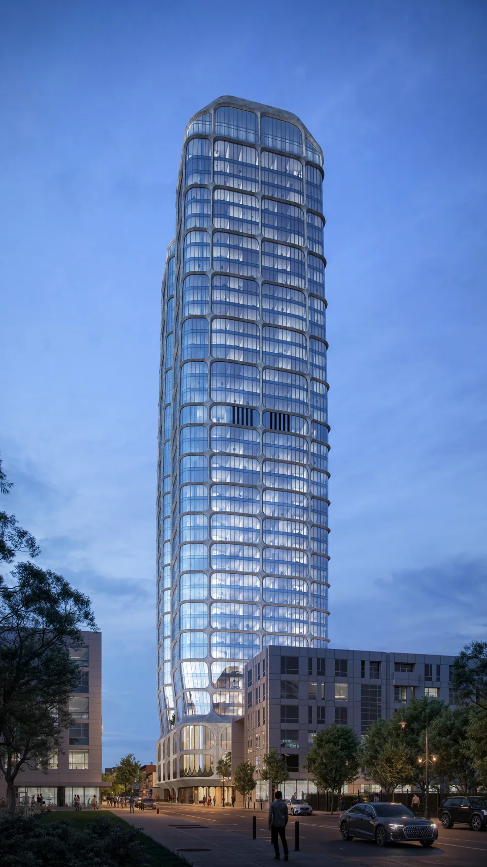 Glass residential tower with a curved crown at 16-24 William Street in downtown Newark at dusk