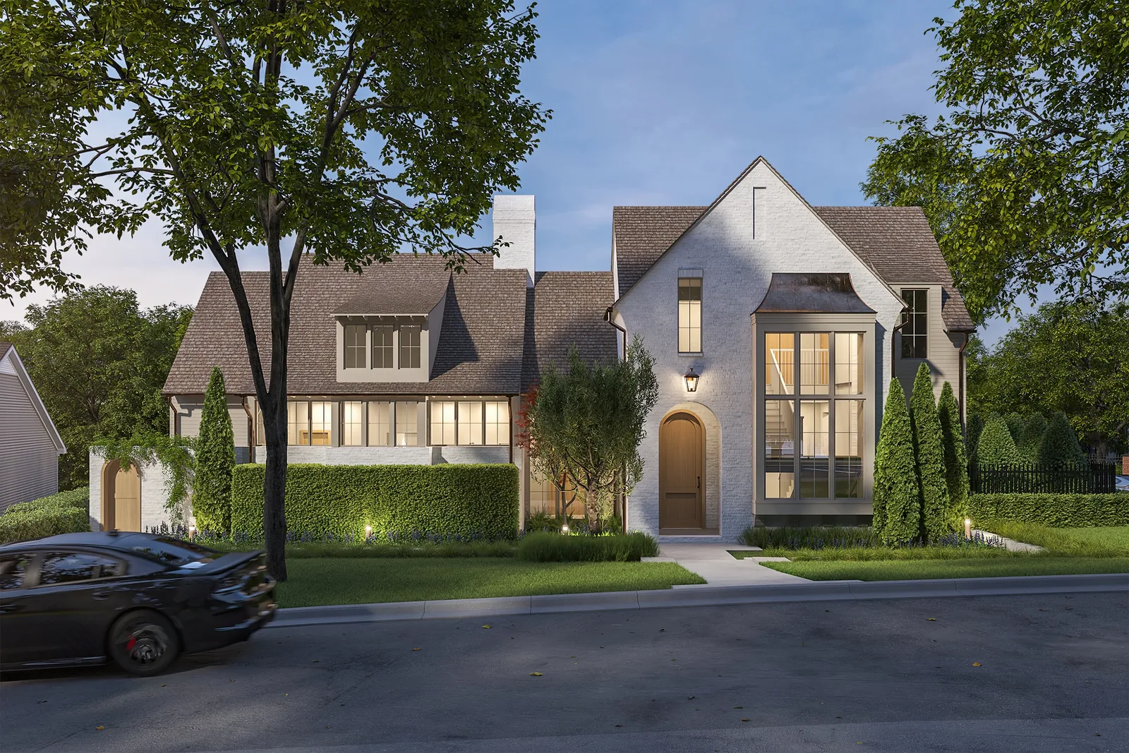 White brick custom home at 2712 Maria Anna in Austin with steep roofs and an arched front door