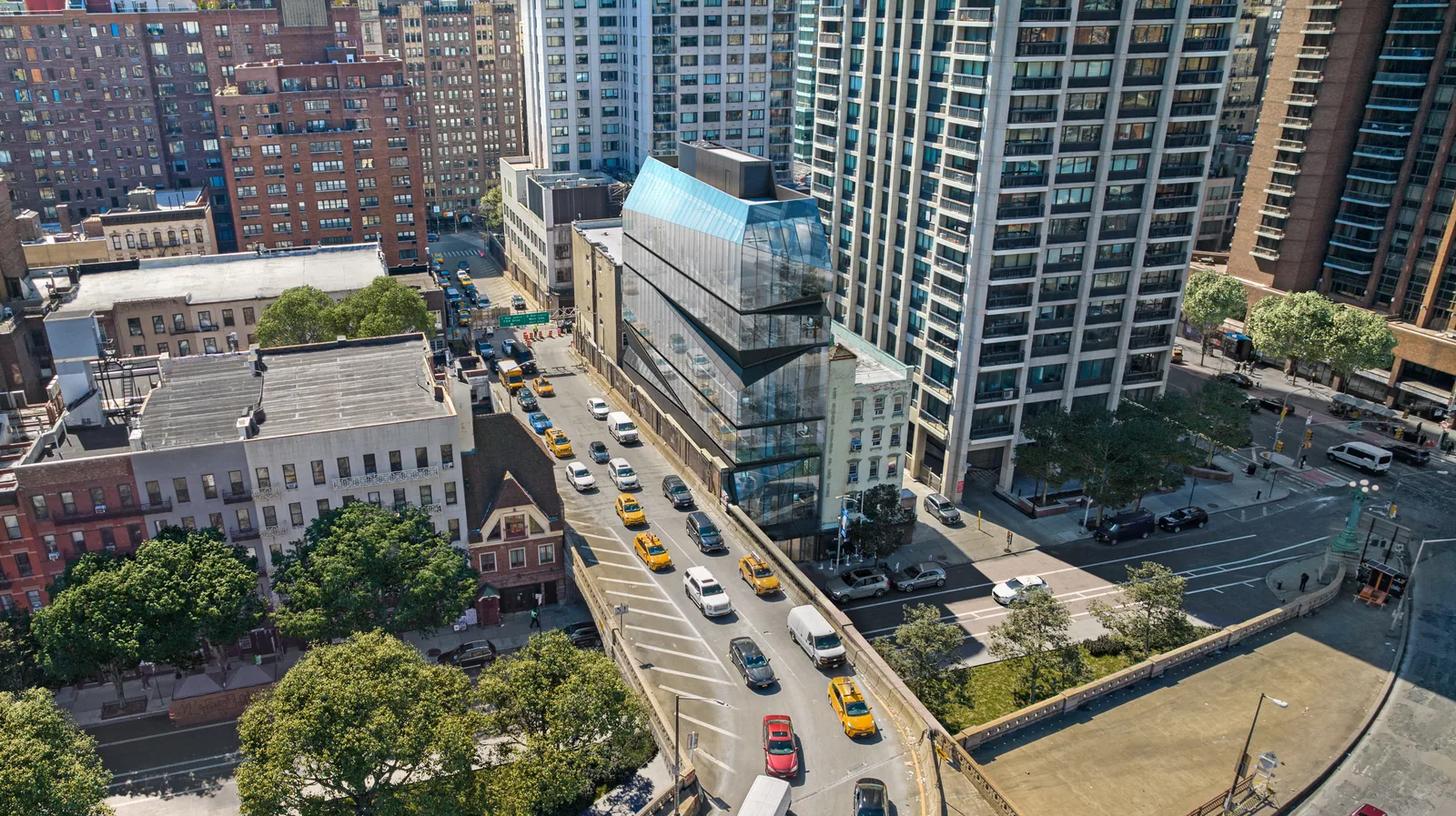 Aerial of E59 Midtown Medical in Manhattan among residential towers and the Queensboro Bridge approach