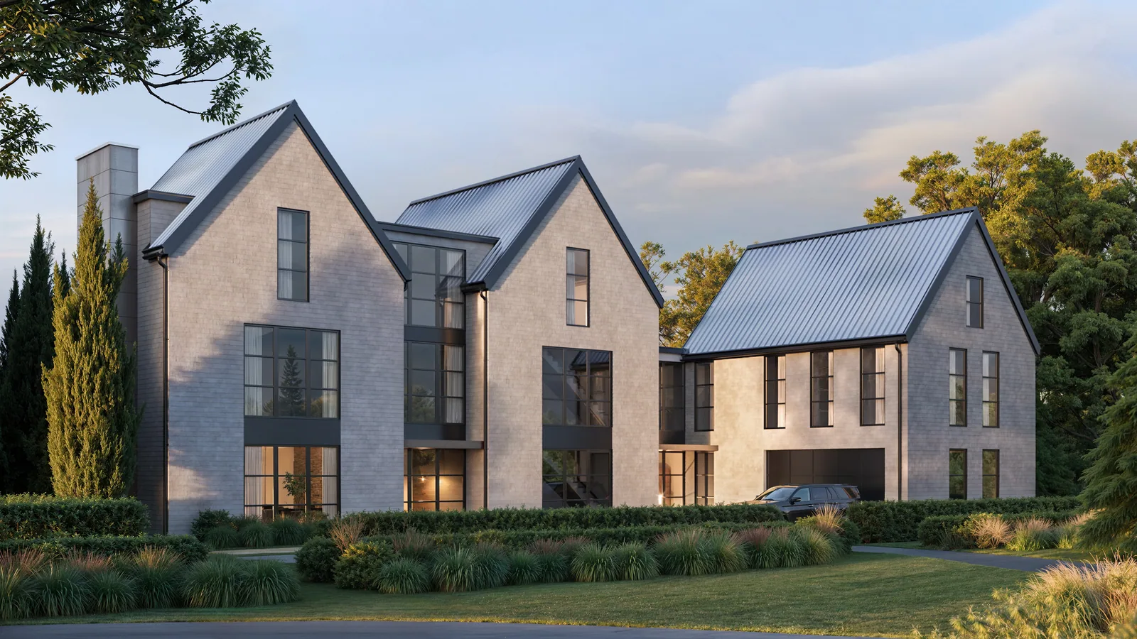 Gabled shingle custom home at 3360 Harness Creek in Annapolis with tall black windows at sunset
