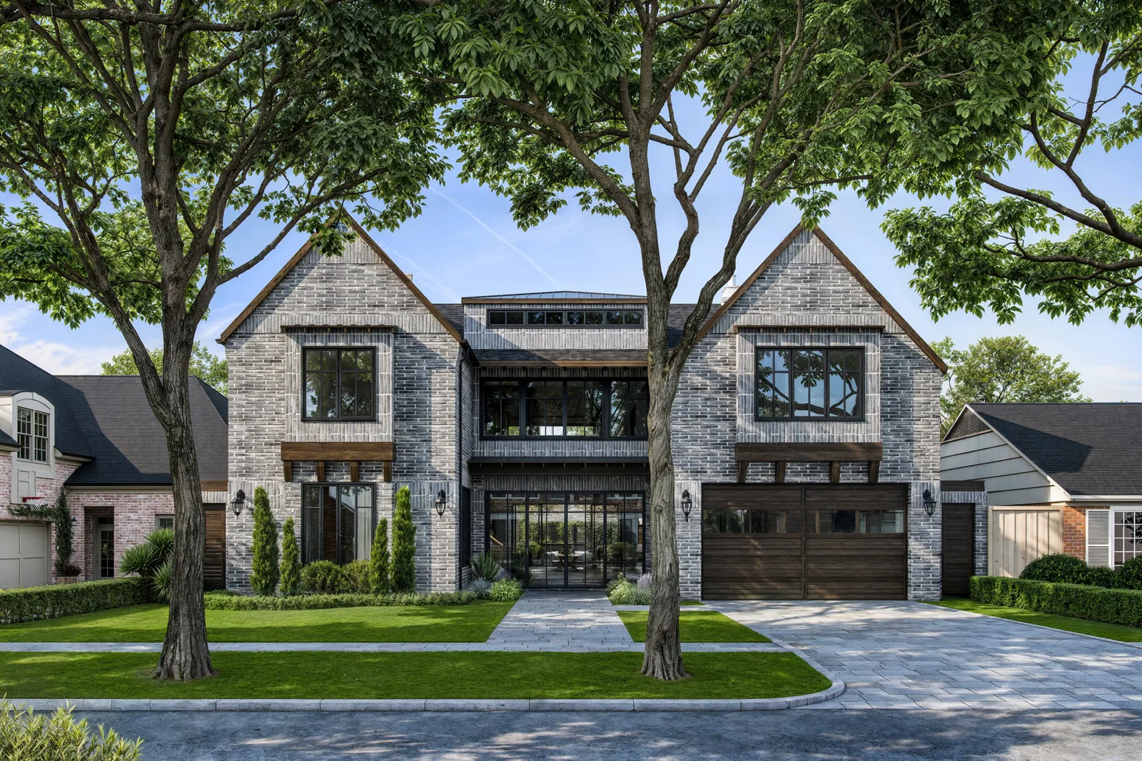 Gray brick custom home with twin gables and glass entry at 3709 Wickersham Lane in Houston