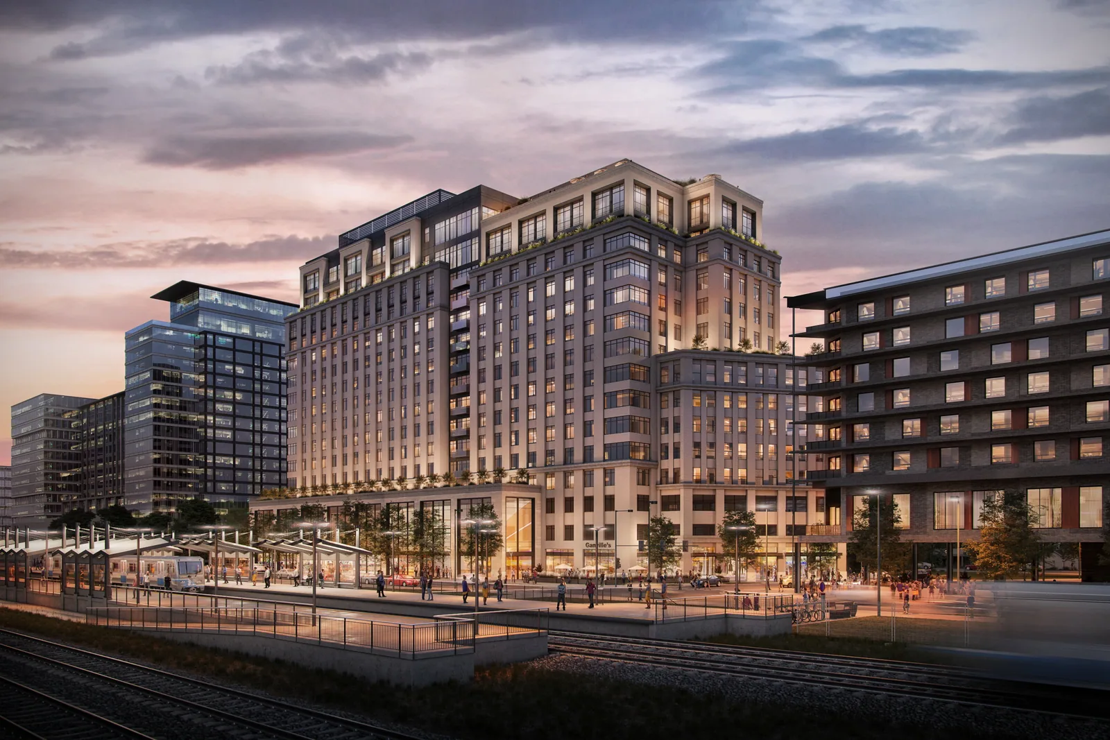 Rendering of the FoundryLine site at 38th & Blake in Denver at sunset, seen across the rail tracks from the station