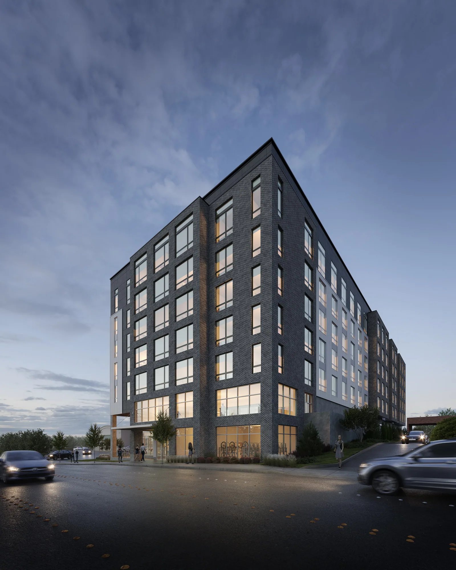 Dark-clad apartment building of Kōz at 4301 Alderwood Mall Blvd in Lynnwood at dusk, corner view