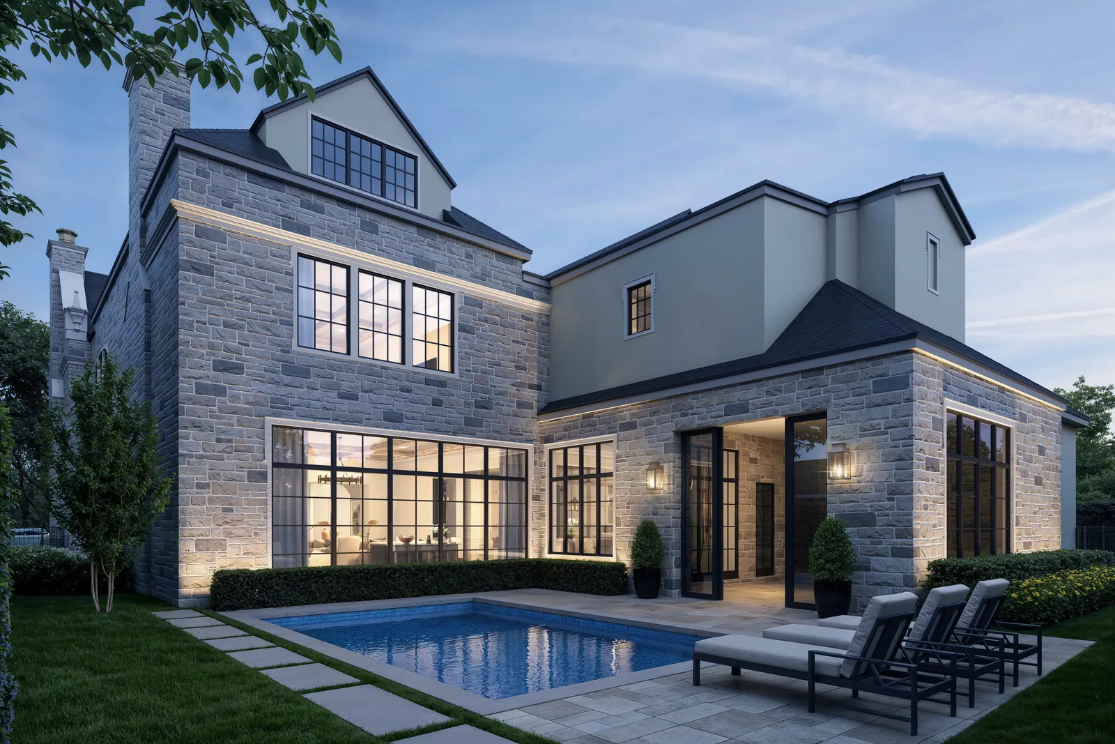 Rear terrace and pool of the 5554 Longmont home in Houston in the evening with steel windows
