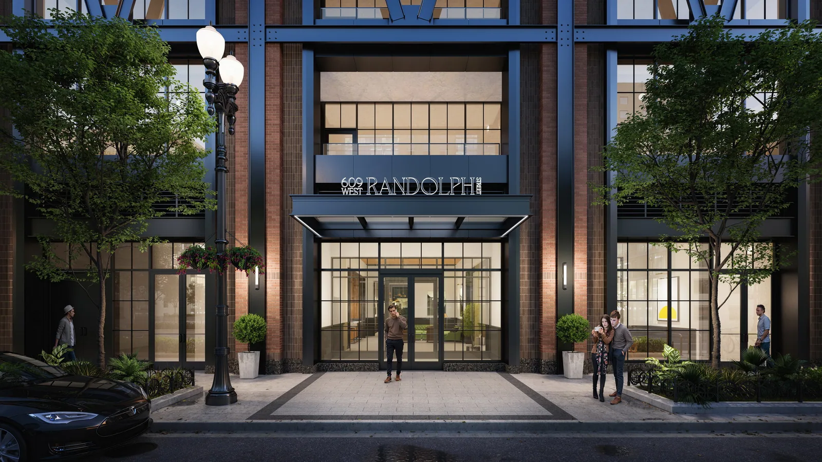 Lobby entrance of 609 West Randolph in Chicago under a steel canopy, with street lamp and trees