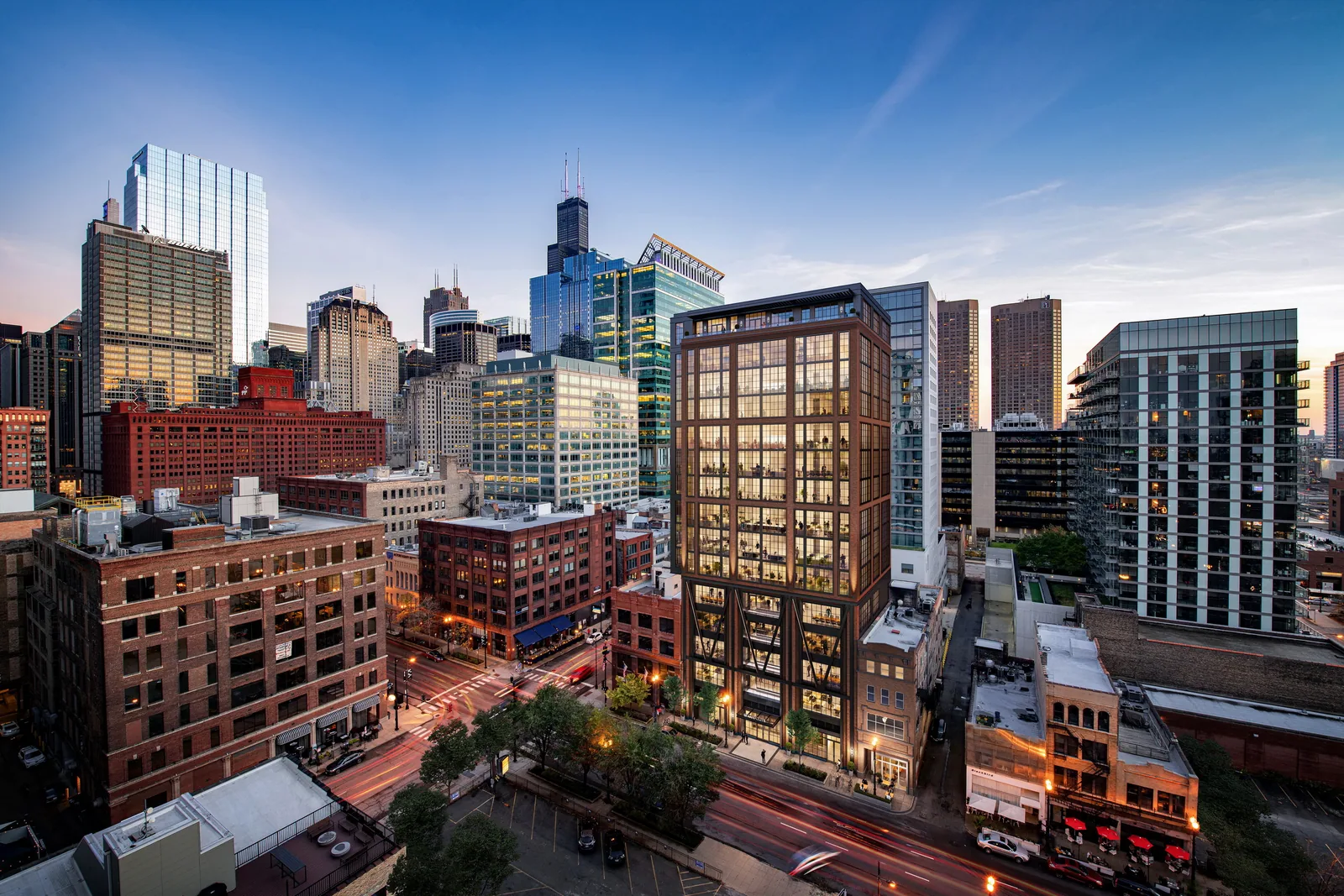 Aerial of 609 West Randolph among West Loop buildings with the Chicago skyline at dusk