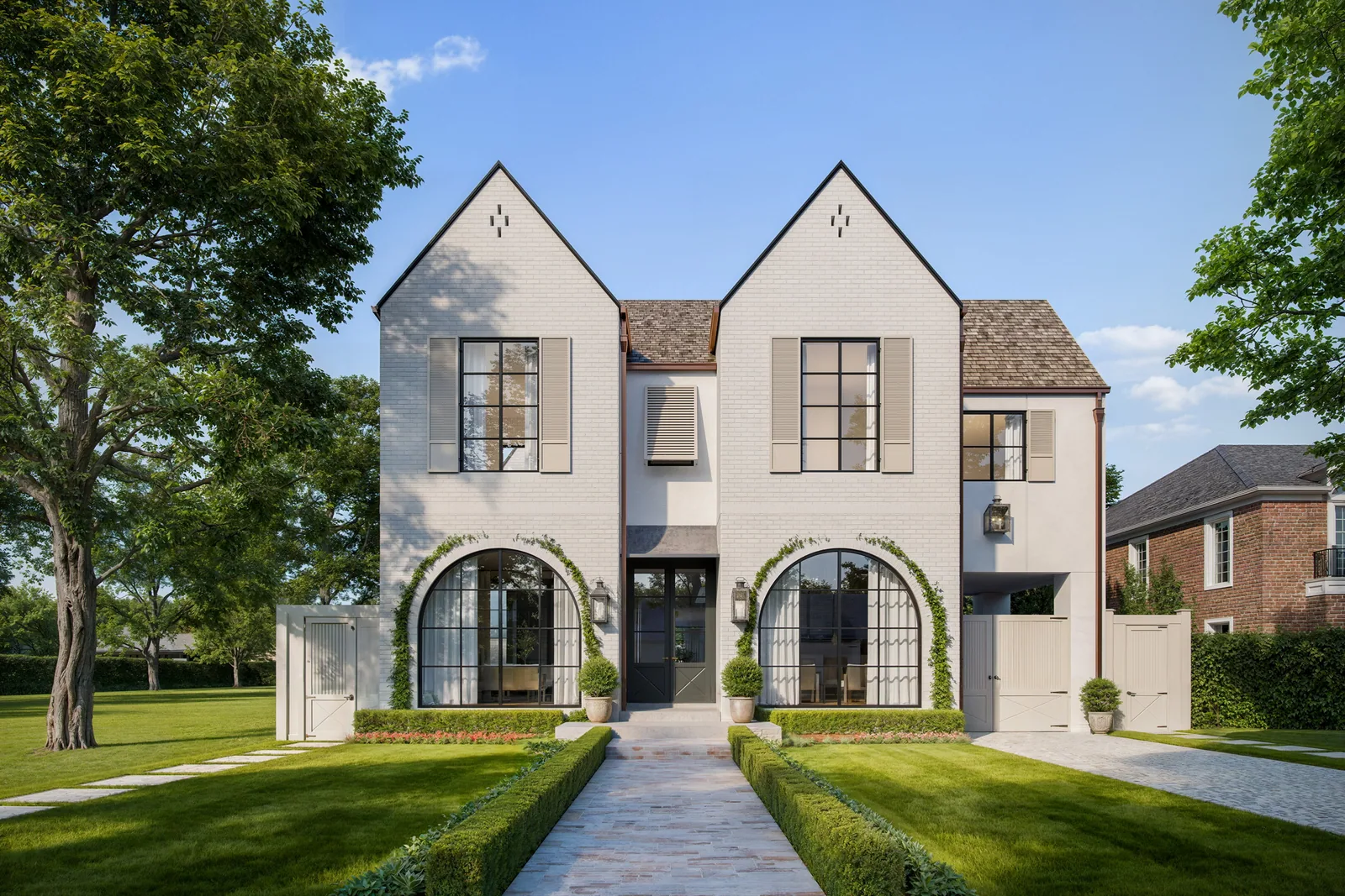Front walk and arched windows of the 6335 Belmont Street custom home in Houston between clipped hedges