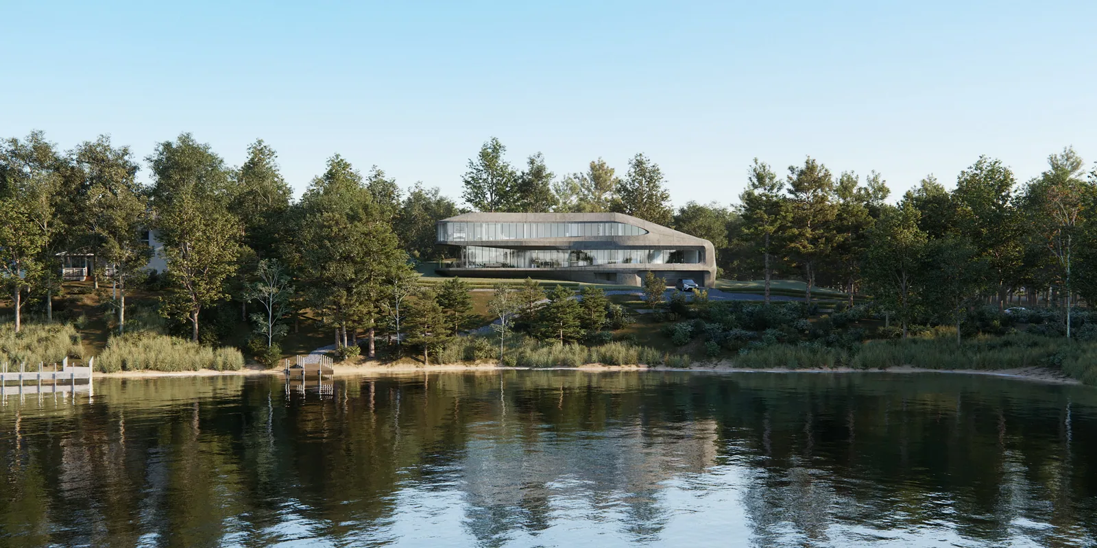 Curving glass and stone home at 8 Hawthorne Rd in Stockbridge seen across a calm lake
