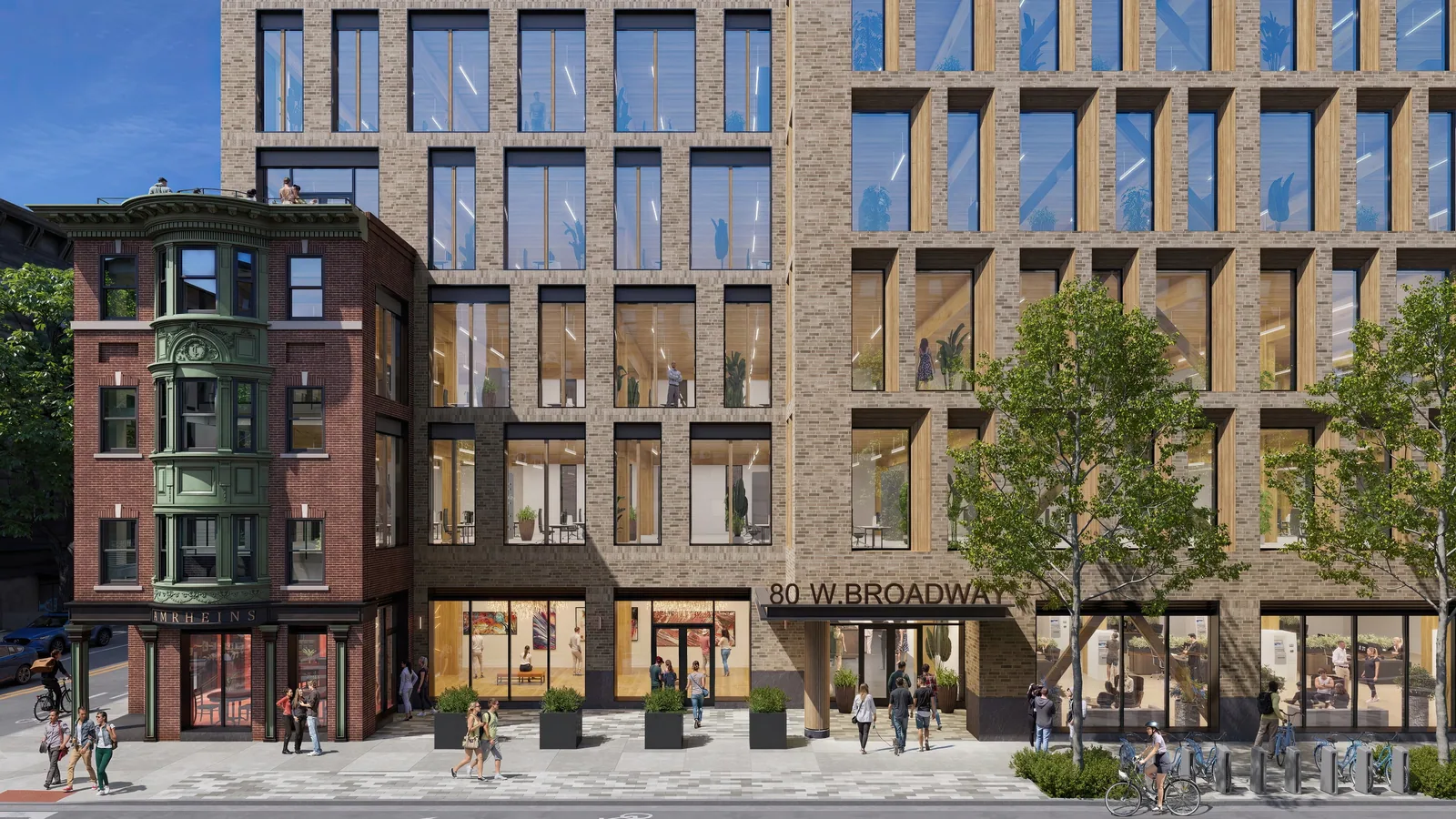 Street frontage and entrance of The Beam at 80 West Broadway in South Boston beside a brick bay-window building