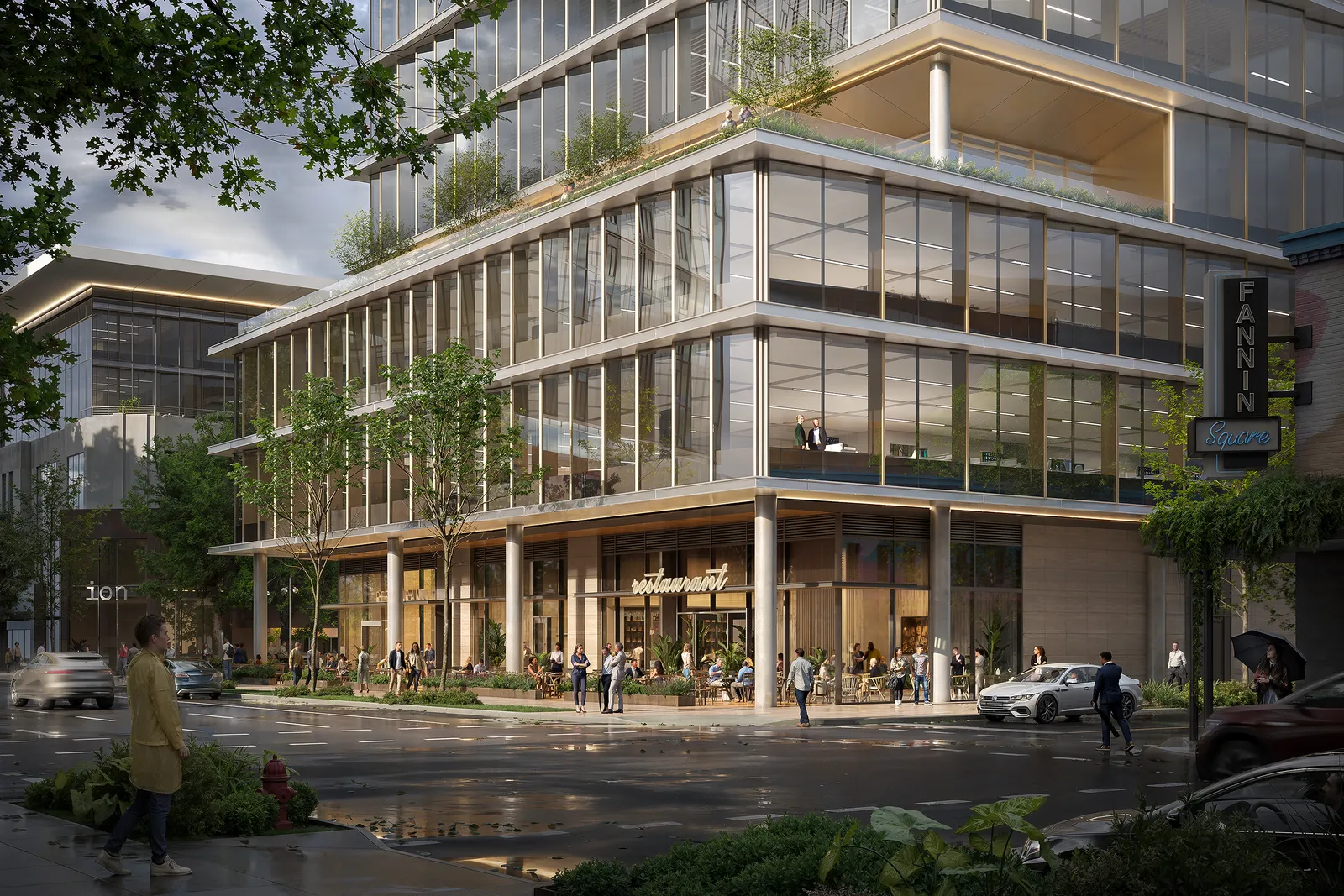 Glass office building with planted terraces and corner restaurant in Houston's The Ion after rain