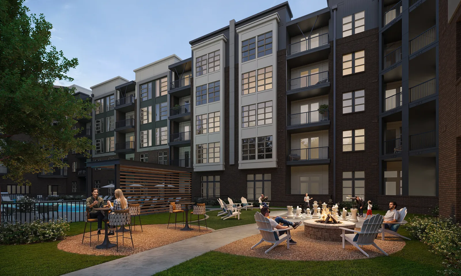 Courtyard with fire pit and lounge chairs between brick apartment buildings at Alta Watkins, Ohio