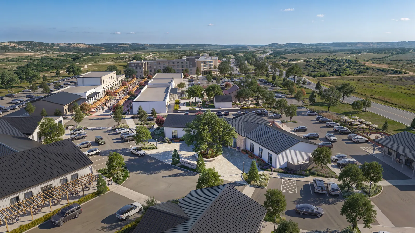 Aerial of barn-style retail buildings and hotel at The Meuse in Fredericksburg, Texas