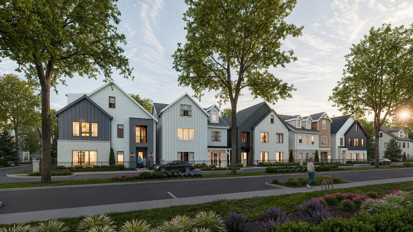 Row of gabled homes in white and dark siding along a landscaped street at The Reserve at Katy Boardwalk, Texas