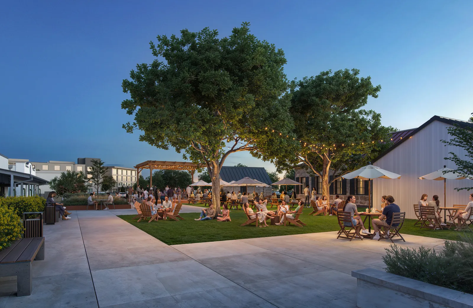 Paved walkway and lawn with diners beside farmhouse-style buildings at Courtyard at dusk