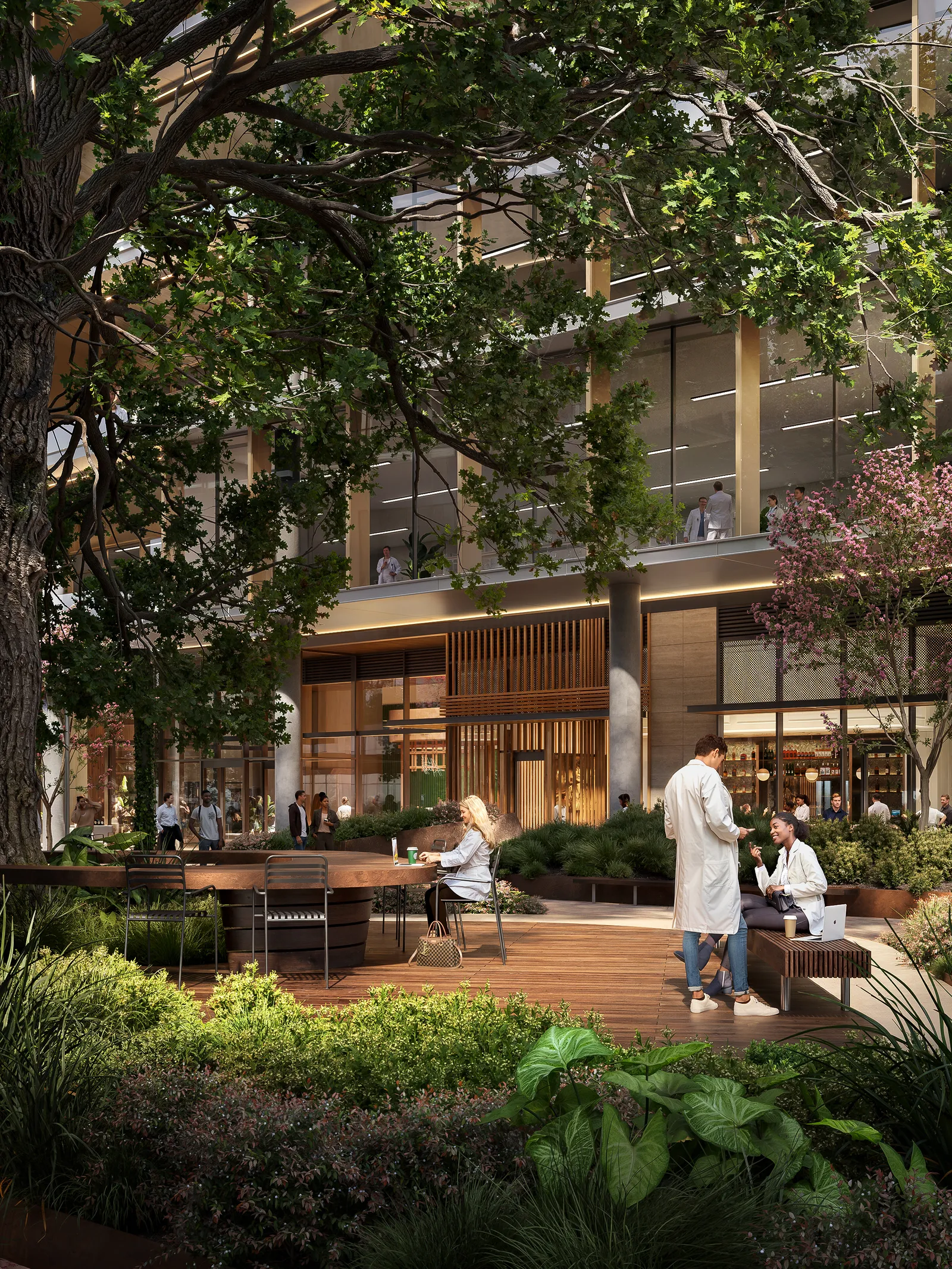 Shaded outdoor seating among plants at a building entrance in Houston's The Ion