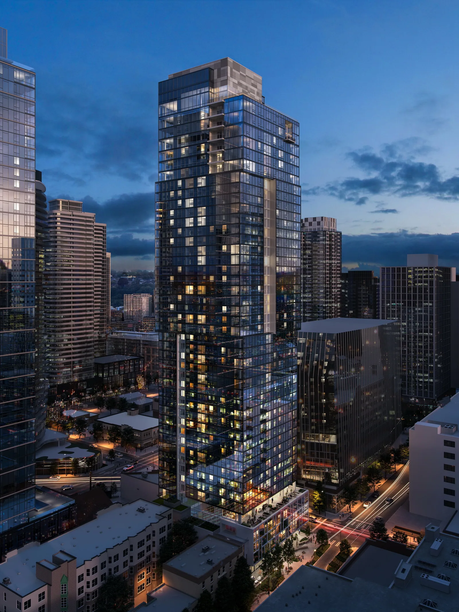 The Ayer residential tower among Seattle's downtown towers at night, aerial view