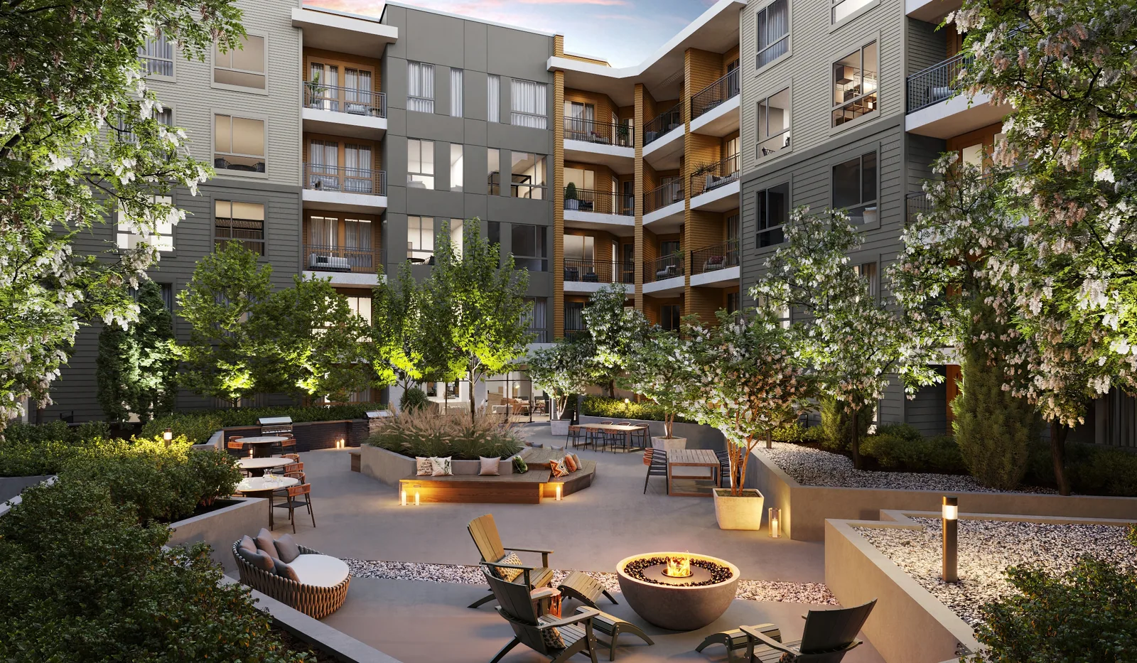 Courtyard with fire pit, lounge chairs and lit planting among apartment buildings at Braxton, Lakewood