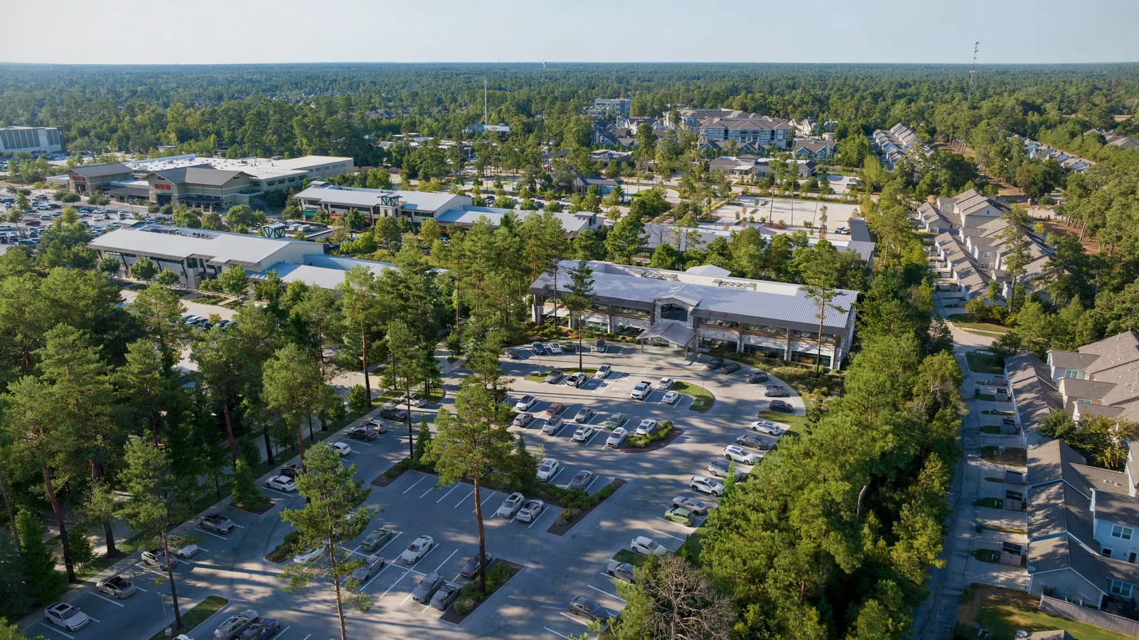 Aerial of the Creekside medical office building among trees in The Woodlands, Texas