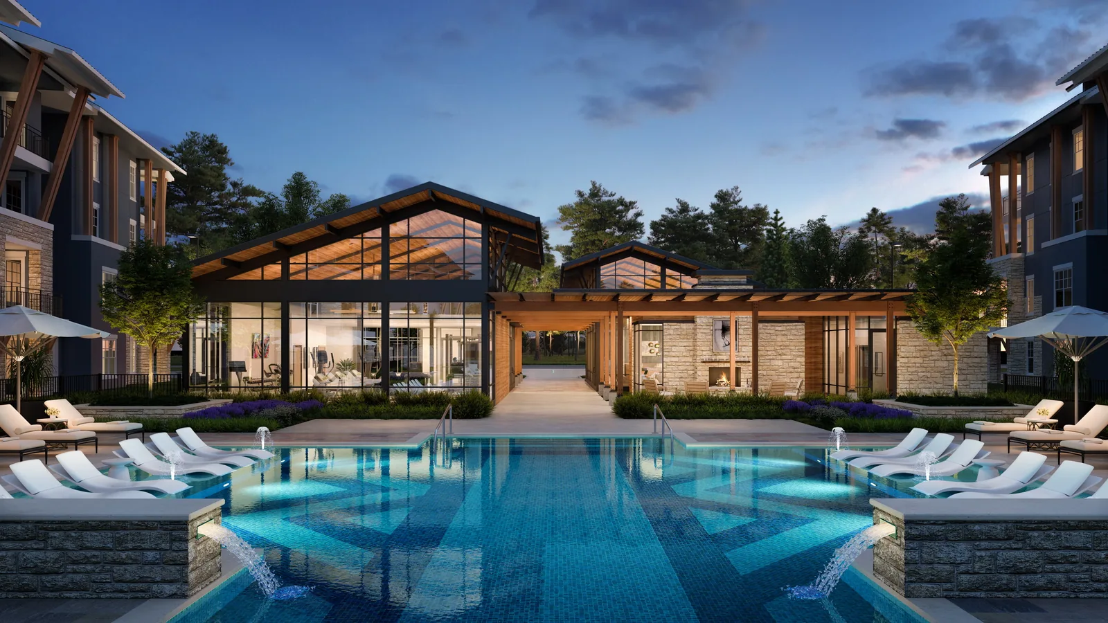 Resort pool and glass clubhouse at dusk at Creekside Park The Grove in The Woodlands, Texas