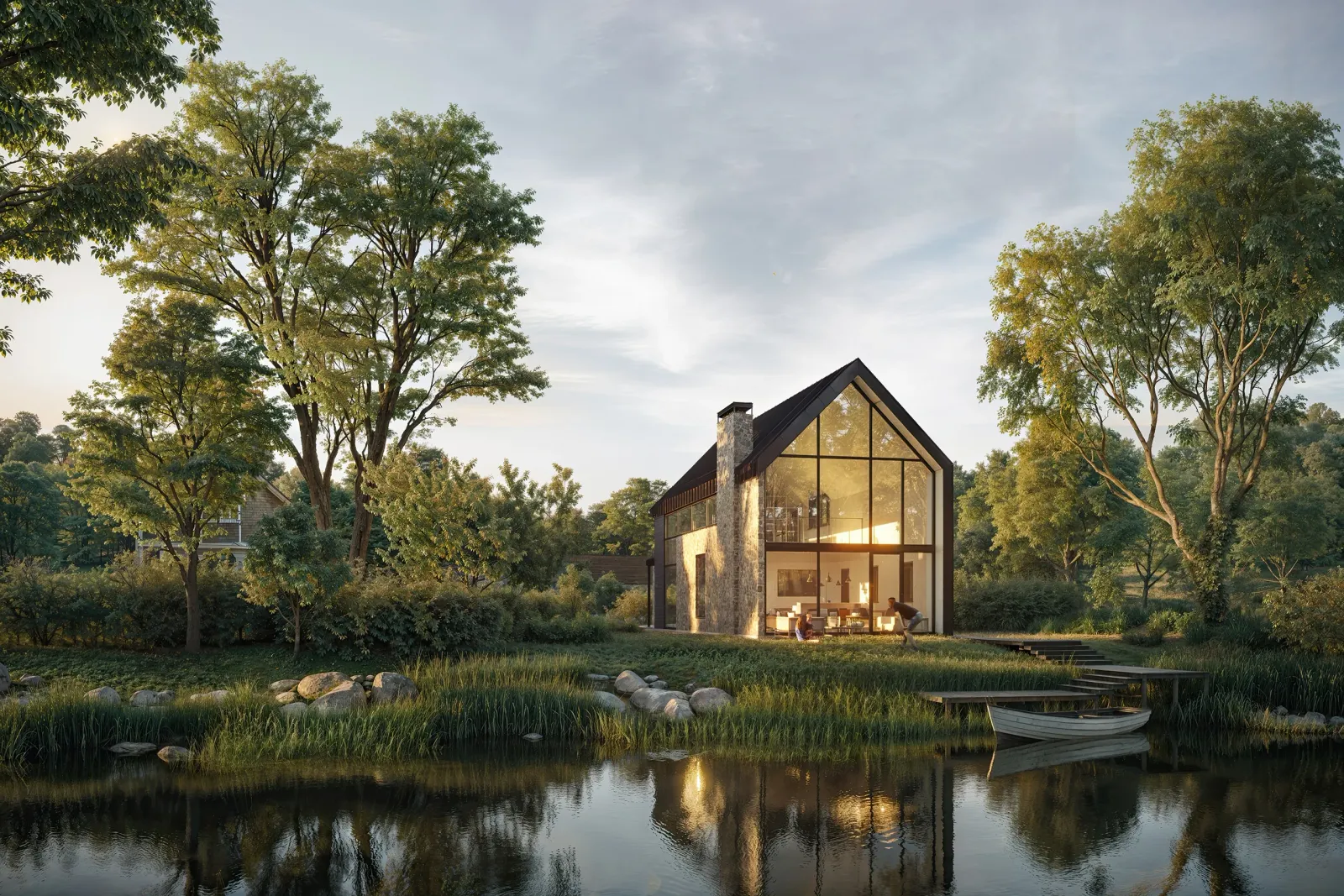 Cabin with glass gable and stone chimney reflected in a pond at dusk, the Darcy home