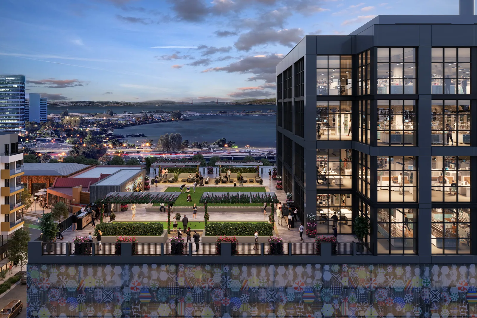Landscaped roof terrace at the Emeryville Public Market tower with the bay at dusk beyond