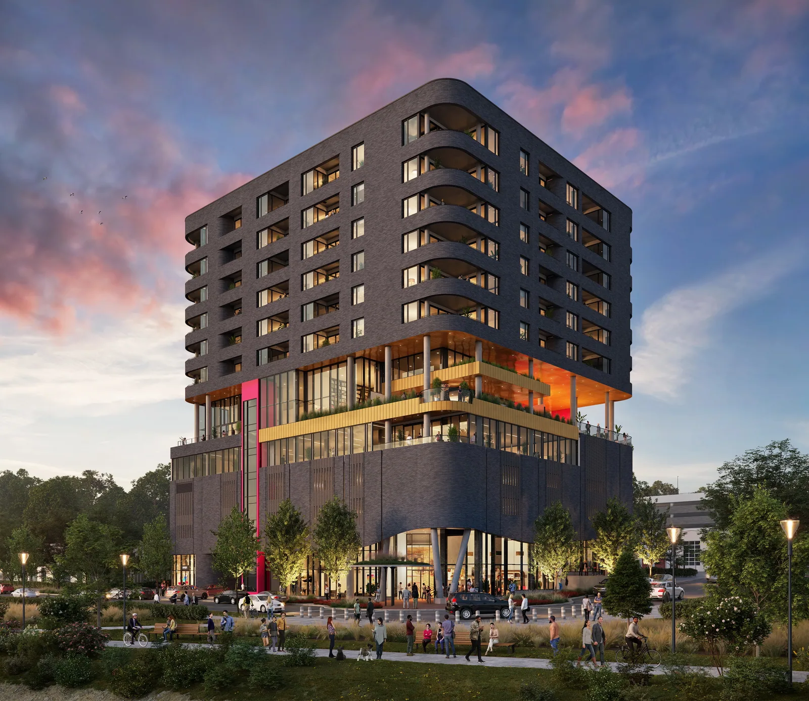 Dark apartment tower with rounded corners and lit amenity floor at Flora RiNo in Denver at sunset