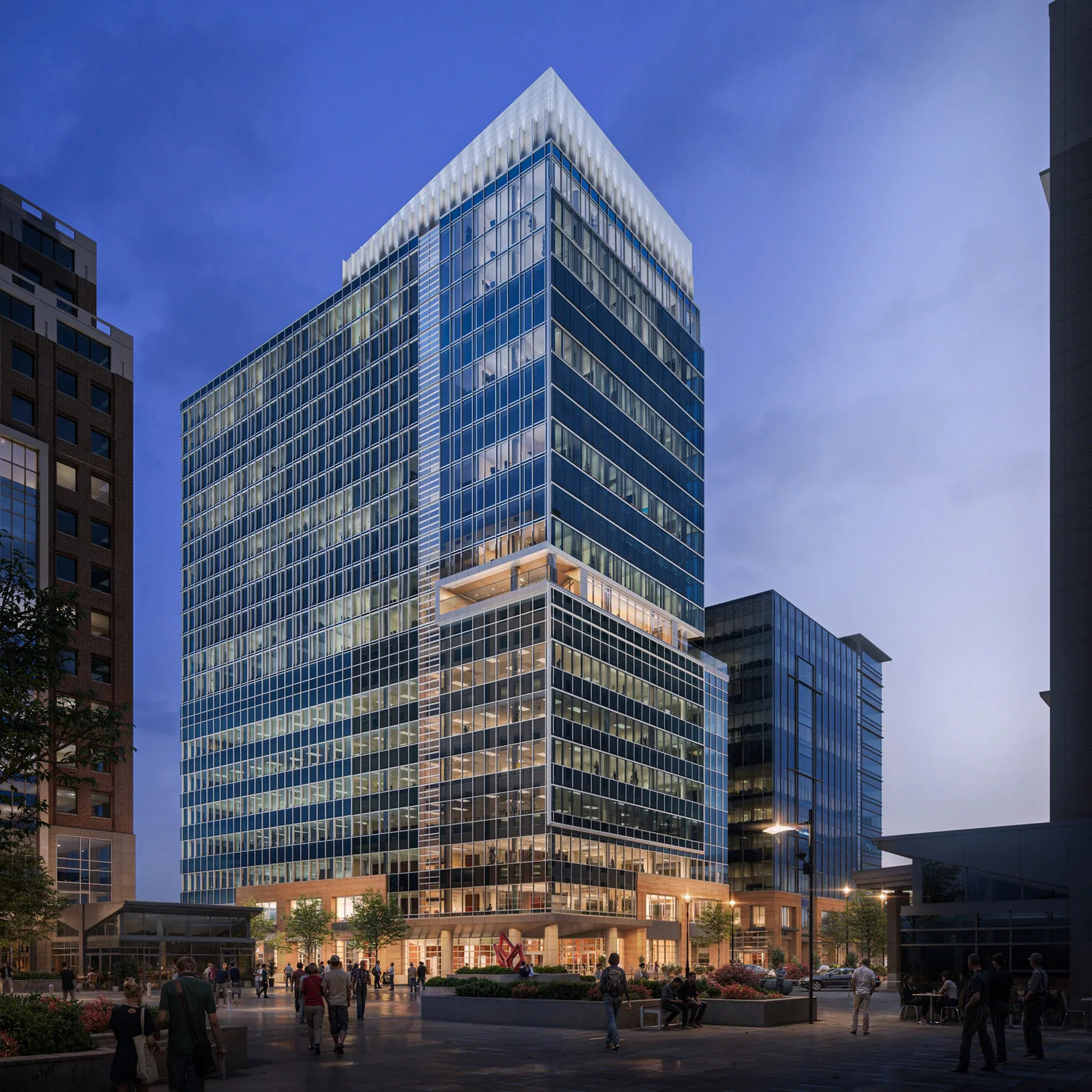 FNB Tower at 501 Fayetteville Street in downtown Raleigh at dusk, glass office floors above a lit plaza