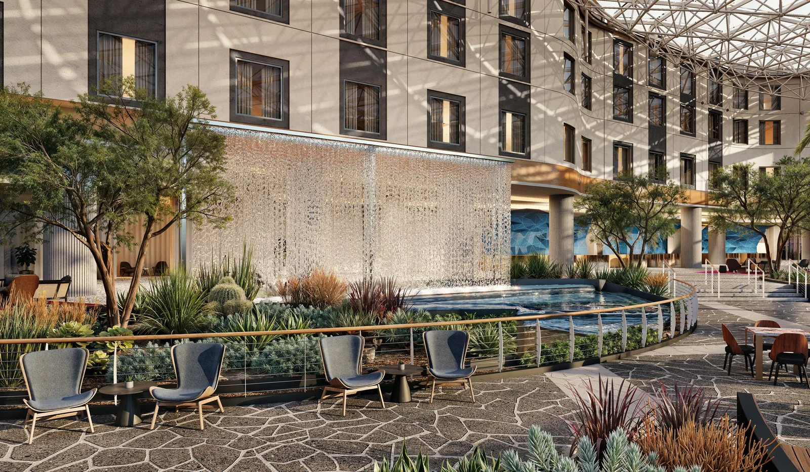 Atrium garden with water curtain, desert planting and seating beside hotel rooms at Gaylord Pacific