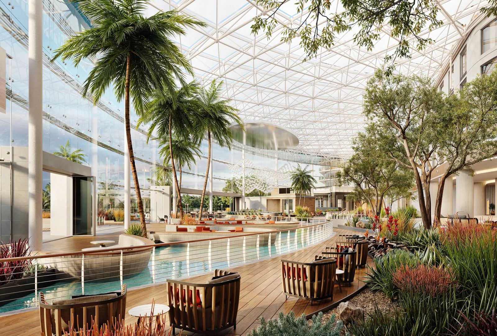 Atrium walkway beside water with palms and lounge chairs under the glass roof at Gaylord Pacific