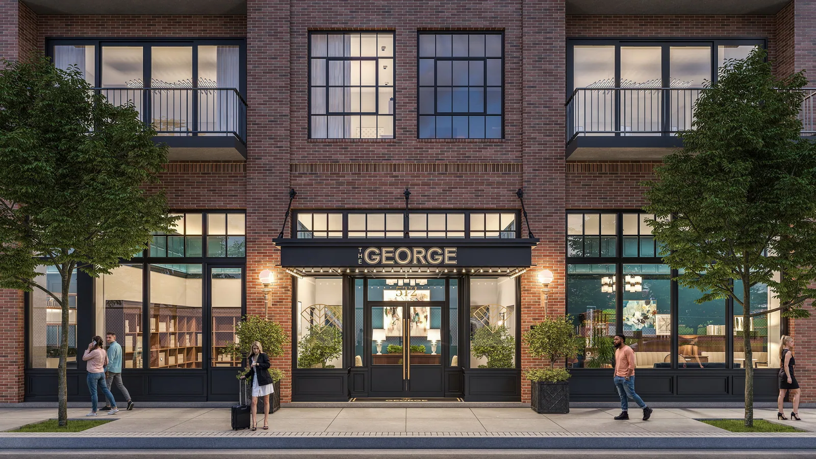 Brick lobby entrance with black canopy and steel windows at The George in Durham