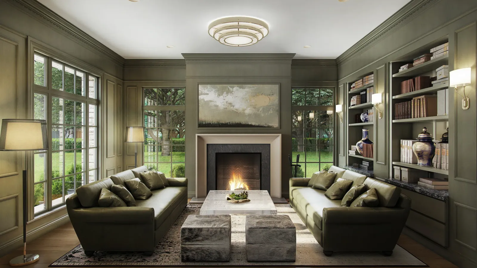 Green-paneled study with fireplace, bookshelves and two sofas at the 5665 Green Tree home, Houston