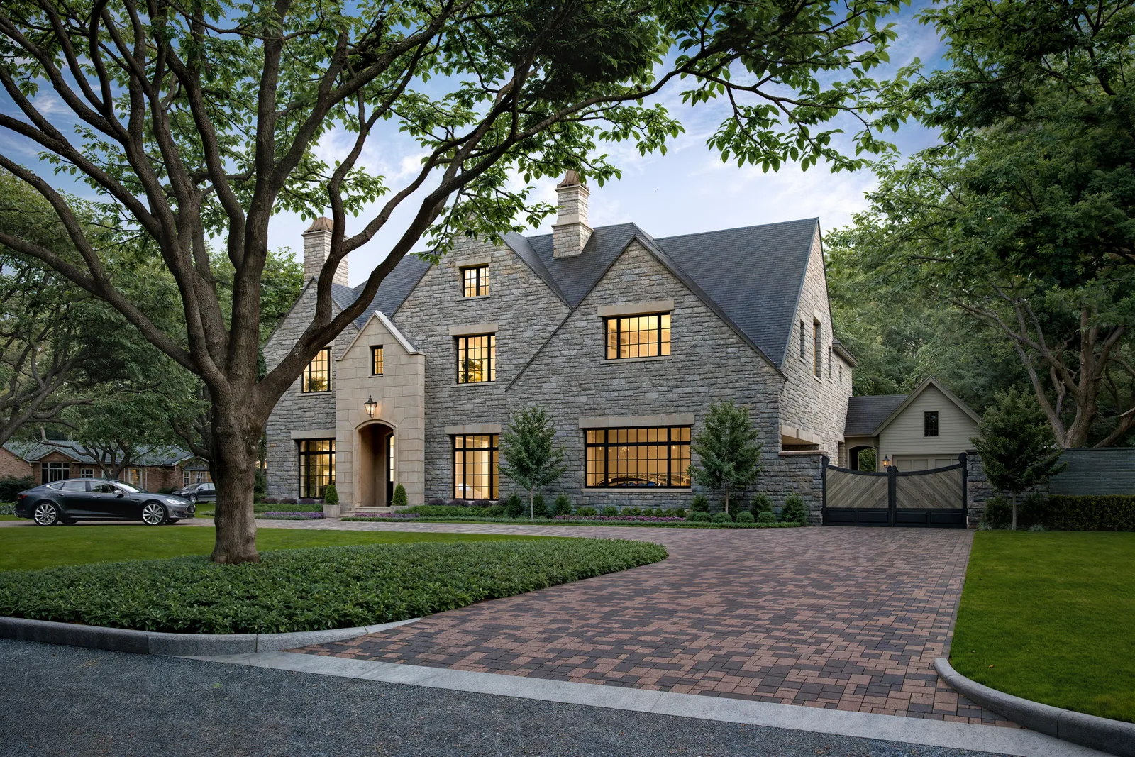 Brick-paved motor court and stone facade of the 5665 Green Tree home in Houston