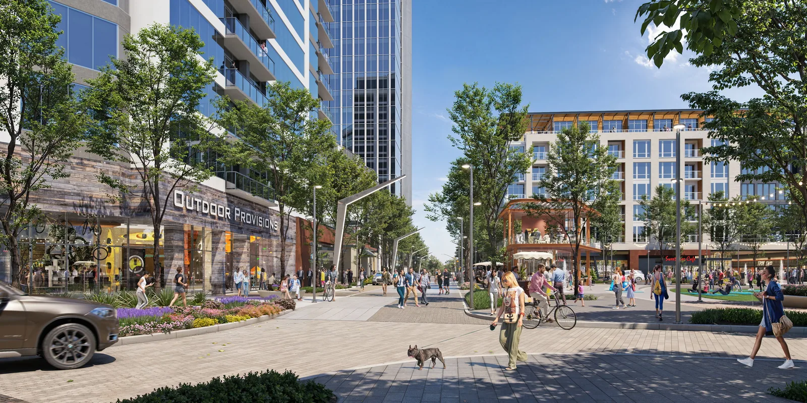 Tree-lined pedestrian street with shops, cyclists and towers at Autry Park in Houston