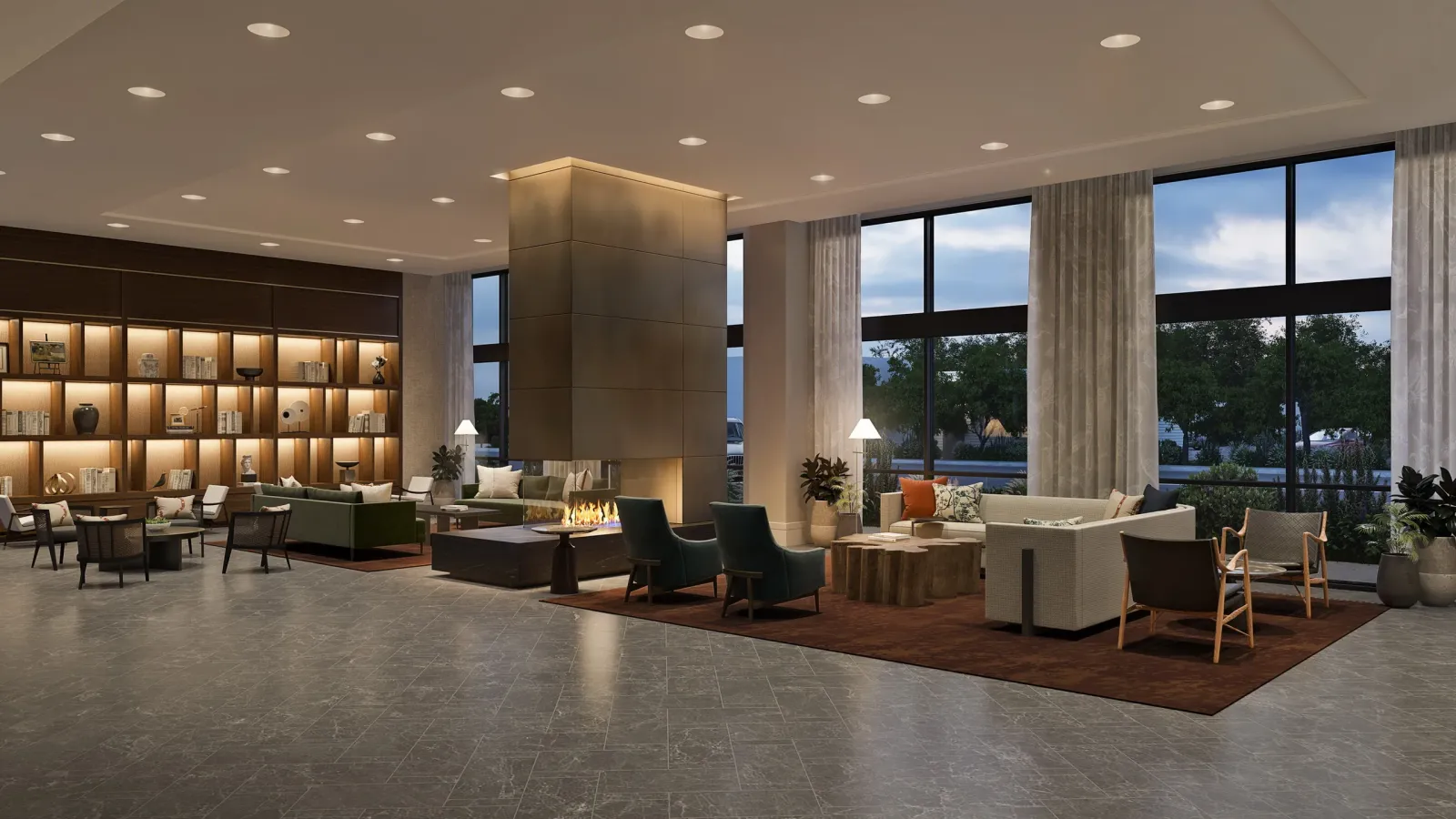Hotel lobby with fireplace column, bookshelves and lounge seating at The Valley Hotel, Homewood