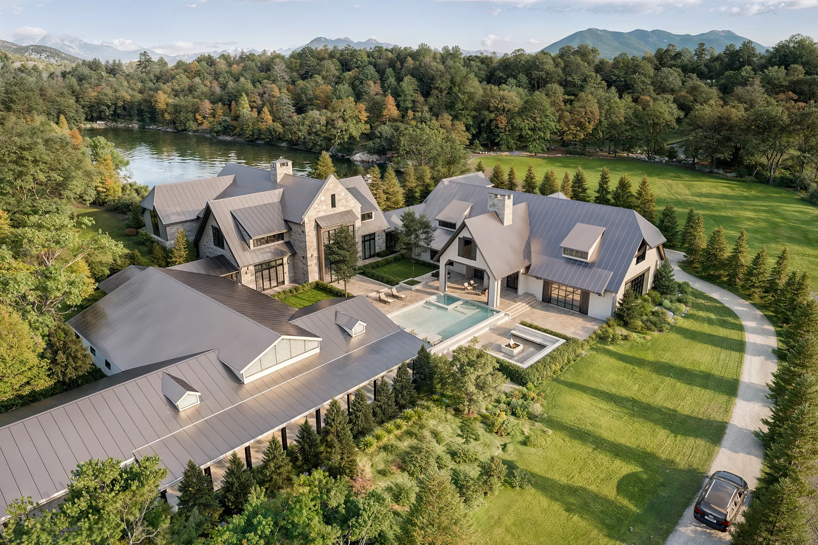 Aerial of the Lickton Pike estate home with pool terrace beside a lake in Whites Creek, Tennessee