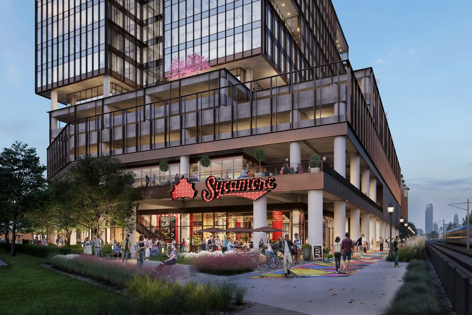 Restaurant storefront and Rail Trail plaza at the base of The Line at 2151 Hawkins, Charlotte, at dusk
