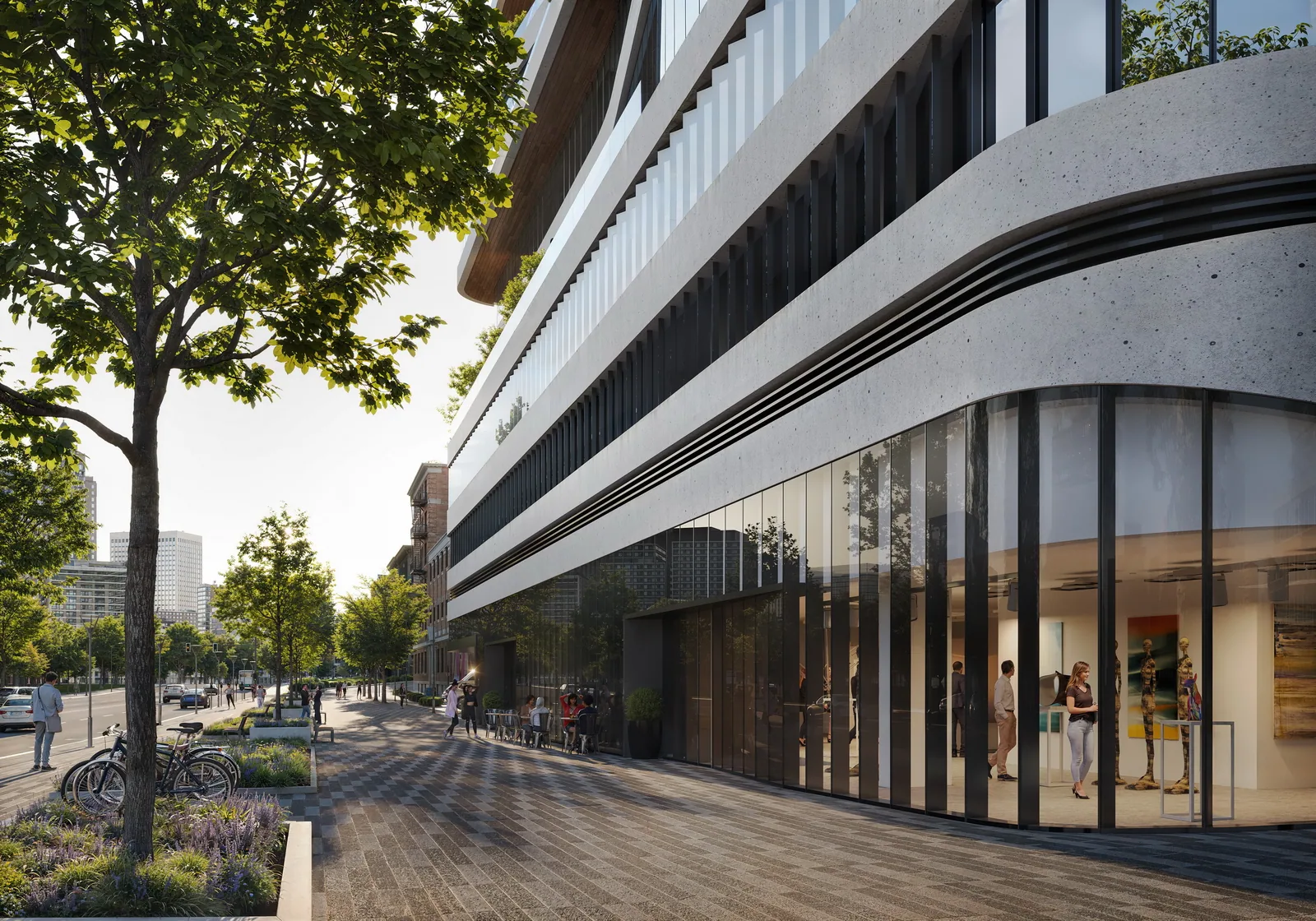 Curving glass base and tree-lined sidewalk at Hudson 44 in downtown Yonkers